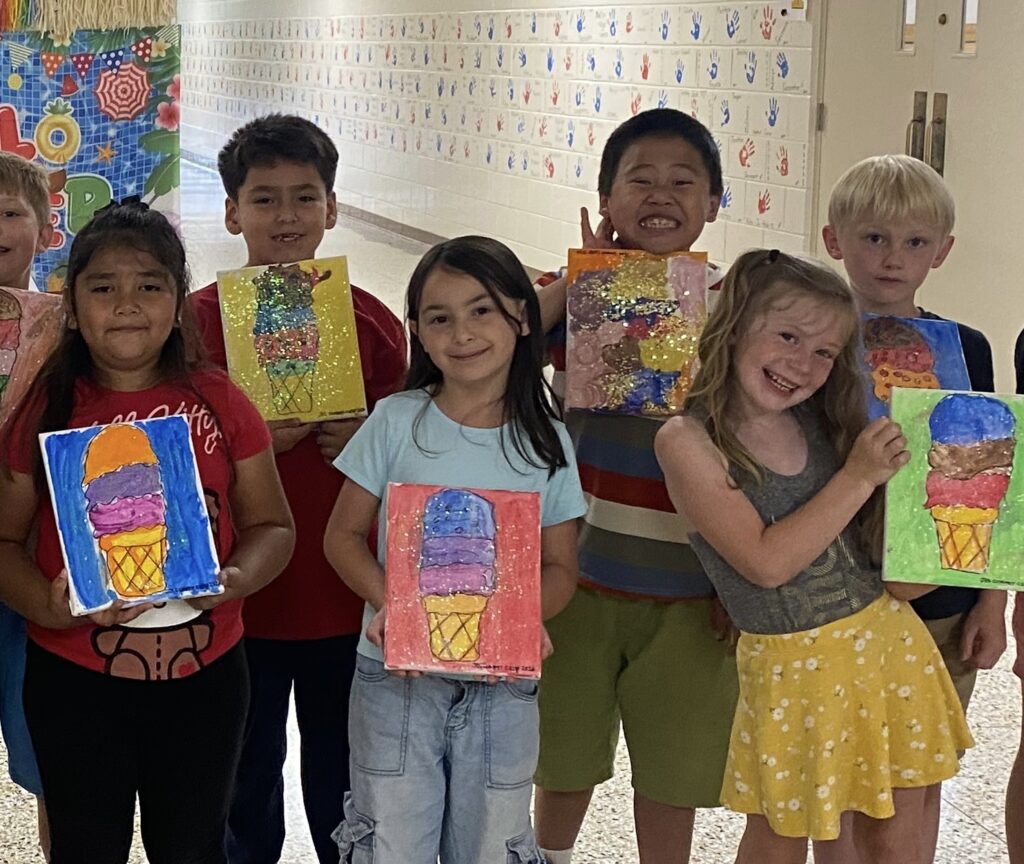 Children holding their artwork